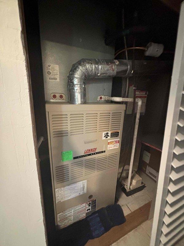 Responded to service call for non-cooling air conditioning system that was found frozen during initial visit and required return after defrost period. Diagnosed 2005 AC unit with R-22 refrigerant leak originating from evaporator coil, resulting in low refrigerant charge and system freeze-up. Provided estimates for refrigerant recharge and evaporator coil replacement, and discussed full system replacement options for aging equipment.