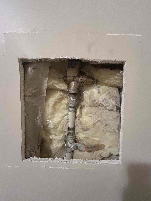 Responded to municipal notification of excessive water usage indicating potential leak on property. Conducted thorough inspection of plumbing system and located leak at shut-off valve assembly behind interior wall access panel. Accessed plumbing chase through existing drywall opening to examine PVC supply lines and brass valve fittings, identifying source of water loss at corroded valve connection requiring repair to bring property into compliance with city water conservation requirements.
