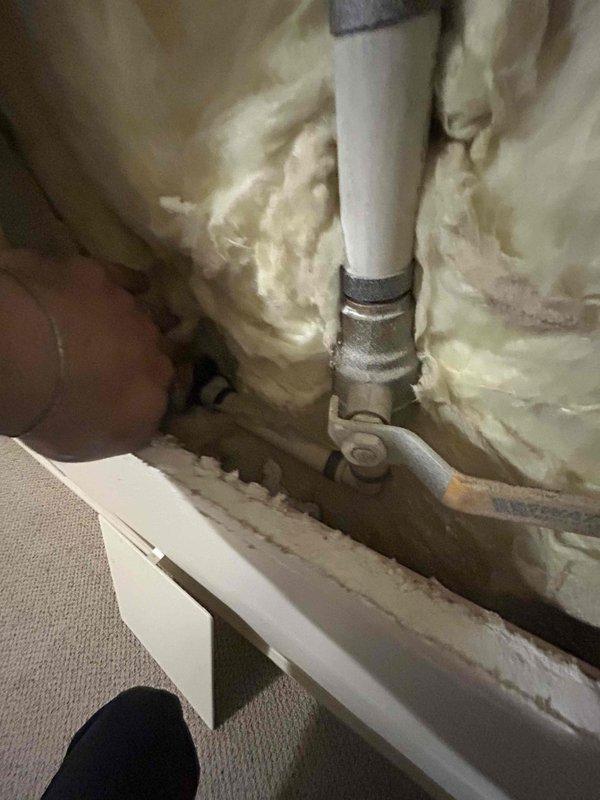 Responded to municipal notification of excessive water usage indicating potential leak on property. Conducted thorough inspection of plumbing system and located leak at shut-off valve assembly behind interior wall access panel. Accessed plumbing chase through existing drywall opening to examine PVC supply lines and brass valve fittings, identifying source of water loss at corroded valve connection requiring repair to bring property into compliance with city water conservation requirements.
