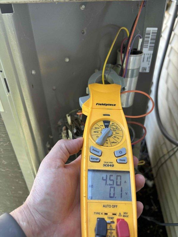 Performed comprehensive cooling system maintenance on 9-year-old outdoor air conditioning unit under membership service plan. Conducted full system tune-up including electrical diagnostics using multimeter to measure compressor amperage and voltage readings. Identified compressor electrical overload issue requiring protective kit installation to prevent future failures. Discovered damaged wire with insulation scraping against metal sheath, creating potential short circuit hazard. Repaired electrical wiring issue under warranty to eliminate safety risk and restore proper system operation. Recommended replacement of 5-inch air filter for optimal airflow and efficiency. Verified system functionality, confirmed heating and cooling modes operational with thermostat displaying proper humidity levels and fan operation in auto mode. Unit returned to safe, reliable operation with all electrical concerns resolved.
