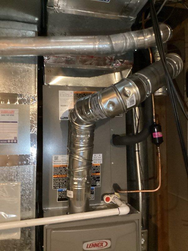 Completed full HVAC system replacement including installation of Lennox ML180UH070E36BK 80% efficiency furnace, ML13KC1-036 3-ton air conditioner, and CK40CT-30/36B-71 evaporator coil. Utilized existing equipment base and flushed existing lineset for reuse. Installed new 20x25x5 filter cabinet beneath furnace with MERV 11 filter. Modified return air system by removing existing 14x14 ceiling grille and cutting drywall to expand return air opening for improved airflow. Installed T6 programmable thermostat for system control. Completed all necessary ductwork connections including flexible and rigid metallic duct installation with proper sealing. Ran copper refrigerant lines and installed PVC condensate drain line with appropriate fittings and shutoff valve. Mounted electrical junction box with conduit for proper power supply to equipment. Installed double-wall venting for furnace exhaust per code requirements. Vacuumed all work areas and removed debris from installation. System tested and