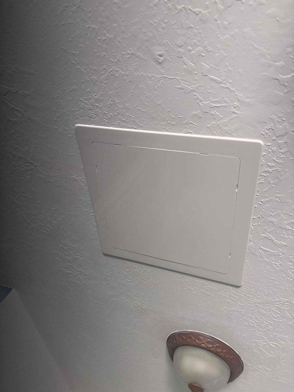 Responded to reported spongy flooring adjacent to shower area in bathroom. Conducted leak investigation to determine source of moisture intrusion causing structural damage to subfloor. Accessed attic space through ceiling panel to inspect plumbing lines and drain connections above affected bathroom. Documented ceiling conditions and access points for further remediation work.