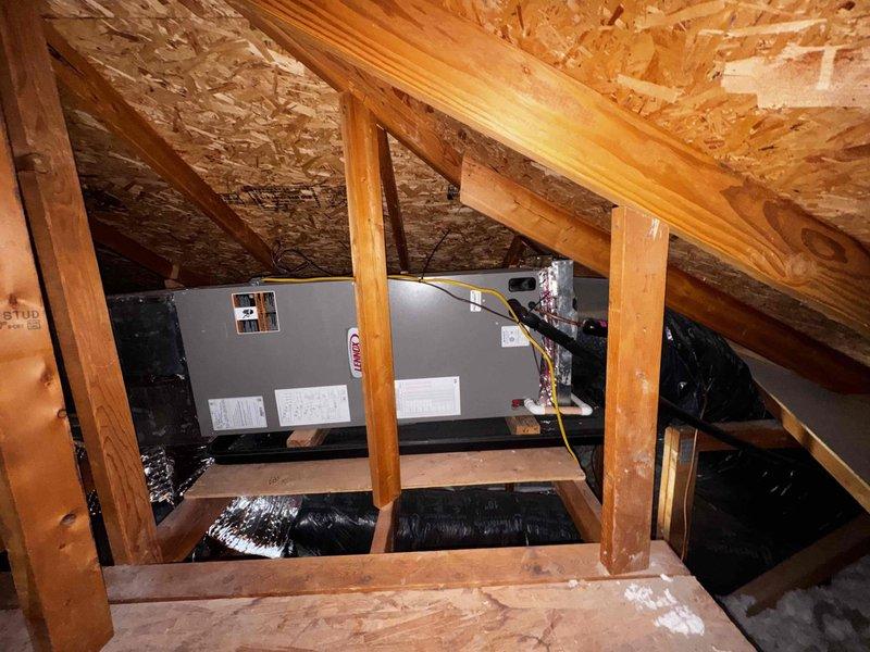 Performed seasonal tune-up on 5-year-old air conditioning system with air handler located in attic space. Accessed attic-mounted equipment, conducted comprehensive system inspection including electrical measurements using clamp meter to verify proper amperage draw and system performance. Inspected air handler unit, flexible ductwork connections, and associated components; system operating within normal parameters with no issues identified.