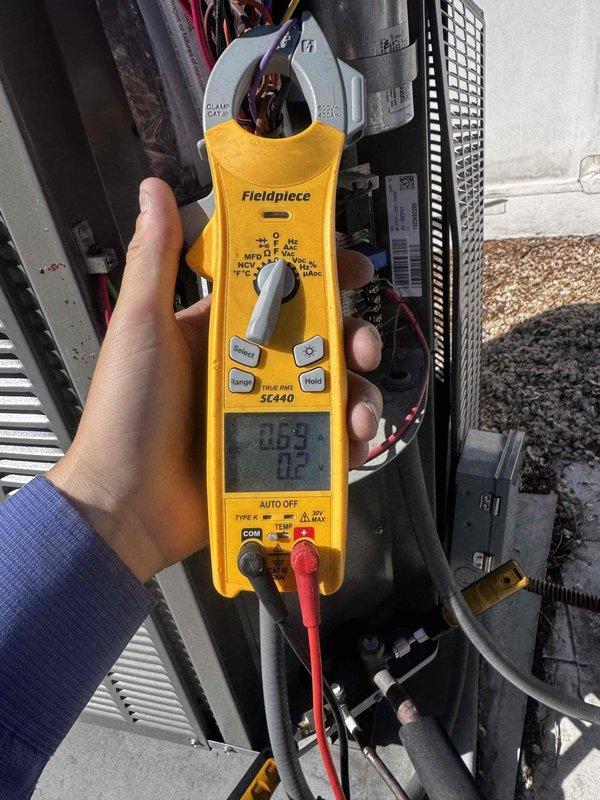 Performed seasonal tune-up on 5-year-old air conditioning system with air handler located in attic space. Accessed attic-mounted equipment, conducted comprehensive system inspection including electrical measurements using clamp meter to verify proper amperage draw and system performance. Inspected air handler unit, flexible ductwork connections, and associated components; system operating within normal parameters with no issues identified.