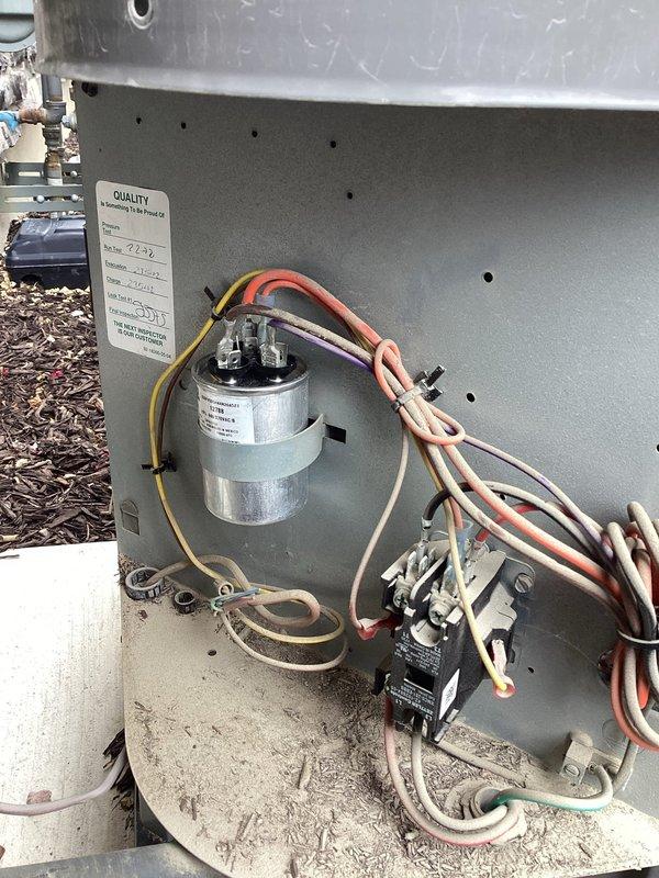 Responded to no-cooling complaint on 8-year-old residential air conditioning system. Upon arrival, confirmed condenser fan motor was not operating while blower was running. Diagnosed failed dual run capacitor preventing condenser fan from starting. Replaced defective capacitor with properly rated unit, restored power, and verified system operation. Condenser fan motor now running correctly, unit cooling properly, and all electrical connections secure.