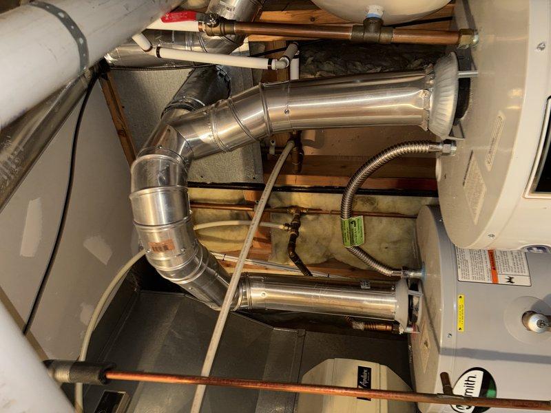 Responded to complaint of brown water throughout home from dual water heater system in basement. Inspected both tanked units (one 2-3 years old, one 7 years old) and identified severe sediment buildup in older unit that had not been flushed in nearly 10 years, causing discolored water distribution. Evaluated anode rod condition, tested water quality, and assessed water softener functionality which was also over 10 years old and potentially contributing to the issue. Provided maintenance recommendations including tank flushing, anode rod replacement, and water softener testing to restore water quality and extend equipment lifespan. Presented replacement options for aging unit including 40-gallon and 50-gallon tanked water heaters with warranty coverage.