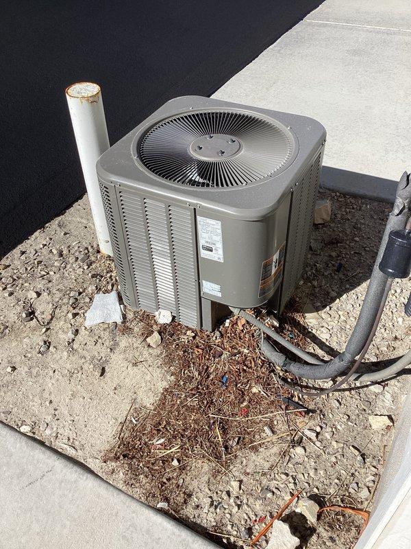Responded to no-cooling complaint on six-year-old Lennox heat pump system, model CX35-36B-6F. Upon arrival, found outdoor condenser unit surrounded by significant debris accumulation including leaves, twigs, and organic material on concrete pad and gravel base. Inspected unit and identified restricted airflow due to debris blockage around condenser coil louvers. Cleared all debris from around unit perimeter and concrete pad to restore proper ventilation. Verified fan operation and checked refrigerant evaporator section per manufacturer specifications. Unit operational at time of departure with improved airflow to condenser.