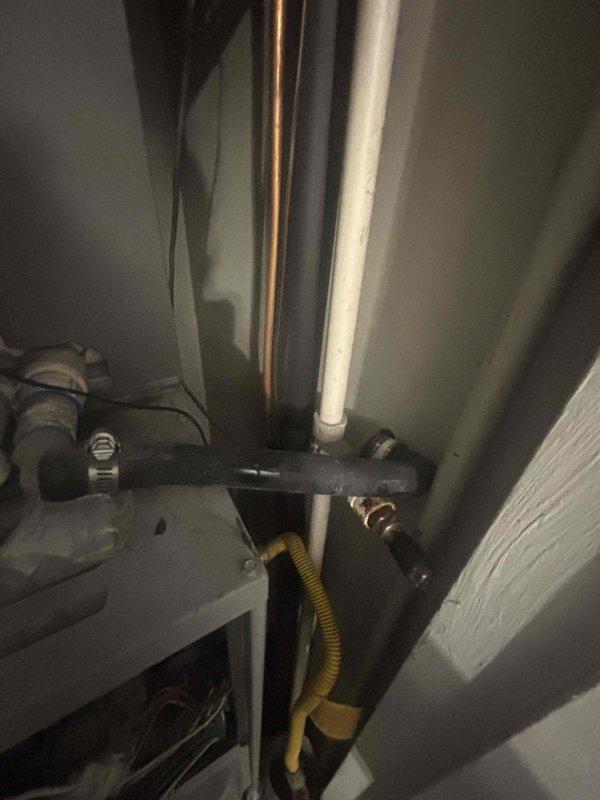 Responded to no-cooling complaint at condominium unit. Upon arrival, performed diagnostic evaluation of air conditioning system with unknown age and service history. Accessed mechanical equipment in utility closet to inspect HVAC components, ductwork connections, and associated plumbing infrastructure. Examined electrical connections, thermostat controls, and determined whether unit was individually controlled or part of building-wide system. Inspected condensate drainage lines, refrigerant lines, and gas line connections for proper installation and functionality. Evaluated system startup sequence and identified root cause of failure to operate. Documented existing mechanical configuration including copper refrigerant lines, PVC drainage, and mounting hardware in confined utility space.