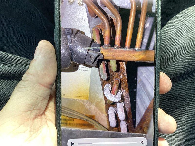 Responded to no-cooling complaint on 10+ year old air conditioning system with ground-level condenser and basement furnace. Performed diagnostic evaluation of system including temperature measurements at supply registers and inspection of refrigerant lines and connections at outdoor unit. Confirmed tenant report that system was blowing air but not producing cool air, requiring further assessment of compressor operation, refrigerant charge levels, and potential component failures to determine necessary repairs.