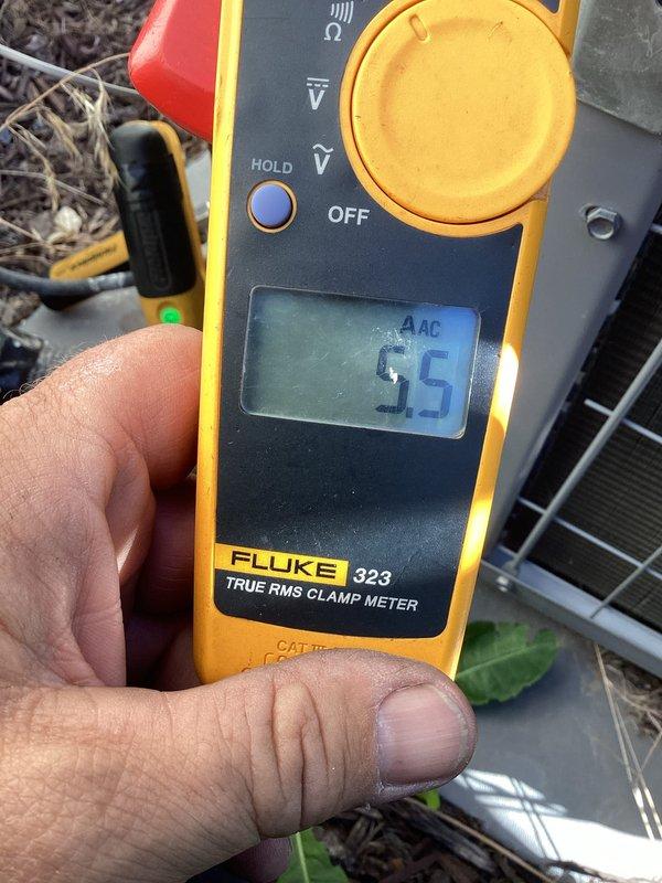 Performed cooling system maintenance on 4-year-old outdoor condensing unit. Measured and recorded compressor amperage at 5.5 amps and fan motor amperage at 8.6 amps, with both readings within normal operating parameters. System operating properly with no issues identified.