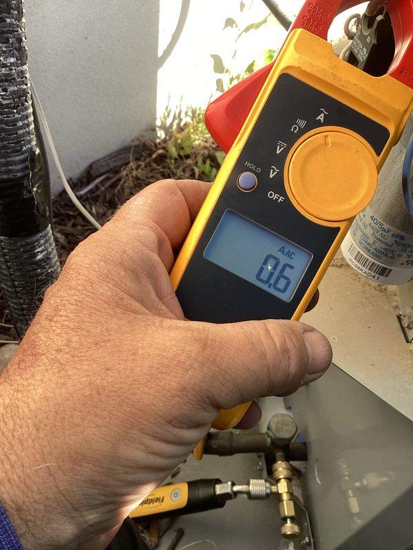 Performed cooling system maintenance on 4-year-old outdoor condensing unit. Measured and recorded compressor amperage at 5.5 amps and fan motor amperage at 8.6 amps, with both readings within normal operating parameters. System operating properly with no issues identified.