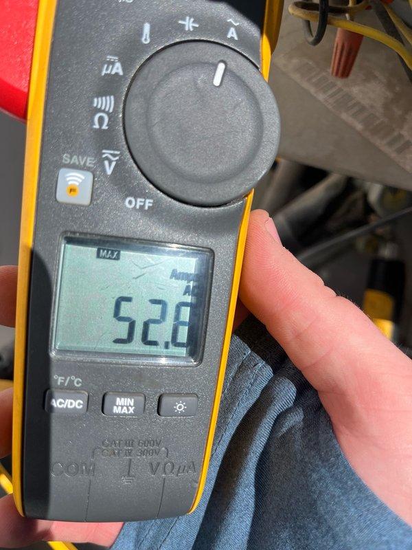 Completed routine maintenance tune-up on an 8-9 year old HVAC unit located on the roof, approximately 10 feet off the ground. Performed standard diagnostic testing using digital multimeter, recording temperature readings of 52.8°F and amperage draw of 5.2 amps during system operation. No issues were reported by customer prior to service, and system showed normal operating parameters throughout inspection. All maintenance procedures completed as scheduled, with photographic documentation taken for service records.