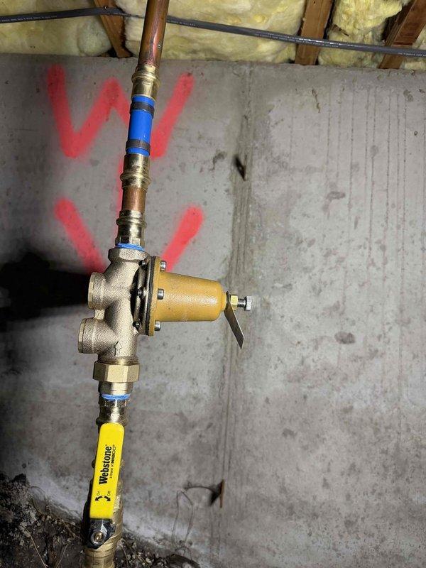 Responded to complaint of high-pitched screaming noise in plumbing system and intermittent low water pressure affecting both hot and cold water lines. Upon inspection, identified water pressure regulator as source of noise and pressure fluctuation issues. Installed new pressure regulator with integral strainer on main water supply line to eliminate vibration and noise while stabilizing system pressure. Tested all fixtures throughout property to verify consistent water flow and pressure restoration, confirming complete resolution of screaming pipes and slow water delivery.