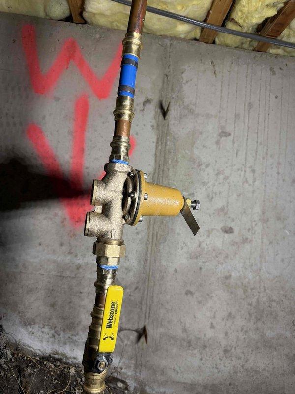 Responded to complaint of high-pitched screaming noise in plumbing system and intermittent low water pressure affecting both hot and cold water lines. Upon inspection, identified water pressure regulator as source of noise and pressure fluctuation issues. Installed new pressure regulator with integral strainer on main water supply line to eliminate vibration and noise while stabilizing system pressure. Tested all fixtures throughout property to verify consistent water flow and pressure restoration, confirming complete resolution of screaming pipes and slow water delivery.