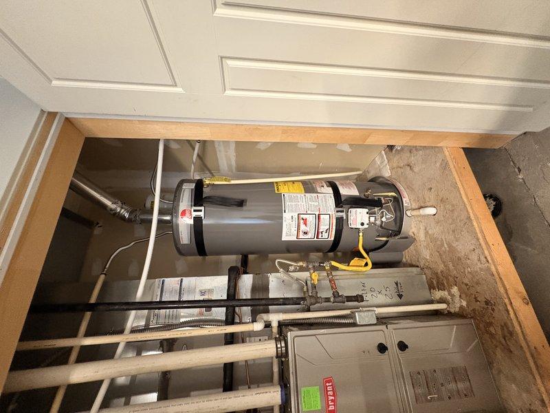 Performed water softener installation consultation at residential property with no existing water conditioning system. Inspected utility closet containing water heater and HVAC equipment to assess available space and plumbing configuration for potential softener installation. Evaluated incoming water supply lines, identified suitable installation location near water heater in mechanical room, and documented existing plumbing layout with photographs for estimate preparation.