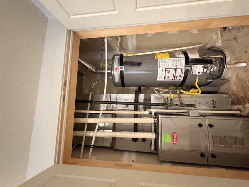 Performed water softener installation consultation at residential property with no existing water conditioning system. Inspected utility closet containing water heater and HVAC equipment to assess available space and plumbing configuration for potential softener installation. Evaluated incoming water supply lines, identified suitable installation location near water heater in mechanical room, and documented existing plumbing layout with photographs for estimate preparation.