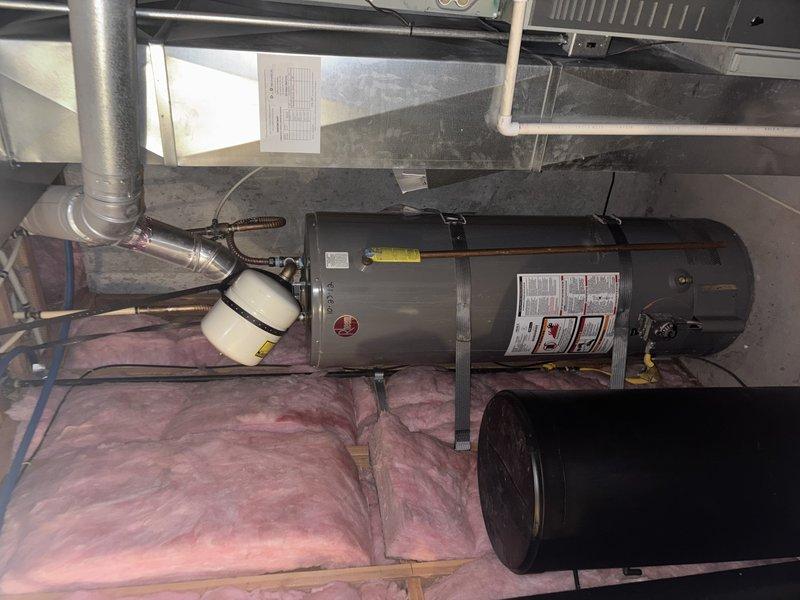 Installed thermal expansion tank on existing water heater system in basement to satisfy home inspection requirements for property sale. Assessed existing water heater condition and discussed code compliance requirements regarding thermal pressure relief. Verified water pressure within acceptable parameters prior to installation. Connected expansion tank to cold water supply line using appropriate fittings and secured unit according to manufacturer specifications. Installation completed with minimal modification to existing plumbing system per homeowner request.