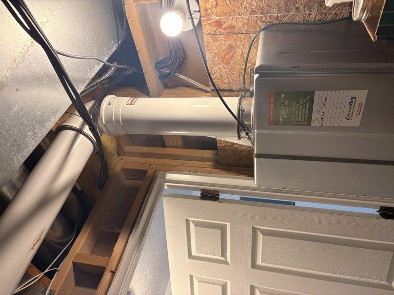 Performed comprehensive inspection and maintenance on tankless water heater unit located in attic space. Examined venting system, electrical connections, and water supply lines for proper operation and code compliance. Assessed PVC piping network and verified proper installation of exhaust and intake vent terminations, confirming all mechanical systems functioning within manufacturer specifications.
