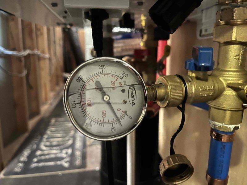 Responded to report of no hot water in middle floor bathroom fixtures while rest of home had normal hot water supply. Investigated PEX manifold distribution system and identified closed isolation valve preventing hot water flow to affected bathroom. Opened valve at manifold to restore hot water to sink and shower. Completed annual plumbing maintenance inspection including water heater evaluation and system pressure check.