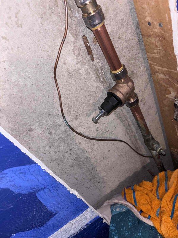Responded to a water pressure issue following recent pressure reducing valve replacement. Upon arrival, inspected the newly installed PRV and approximately 6 inches of copper piping that had been replaced due to a leak above the original valve. Diagnosed inadequate water pressure throughout the residence. Evaluated PRV settings, brass fittings, and copper pipe connections to identify the cause of pressure loss. Adjusted pressure reducing valve to restore proper water pressure to the 28-year-old home's plumbing system.