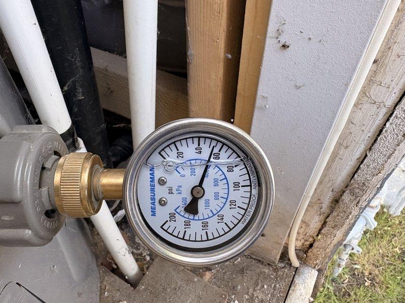 Performed comprehensive water heater flush and safety inspection on Rheem standard tank unit experiencing knocking sounds. Completed full system flush to remove sediment buildup, inspected all plumbing connections including copper supply lines and gas line, verified proper operation of temperature and pressure relief valve, and tested pressure gauge readings. Confirmed expansion tank installation and drain pan placement, examined all visible piping and connections for leaks or deterioration, and verified proper venting configuration.