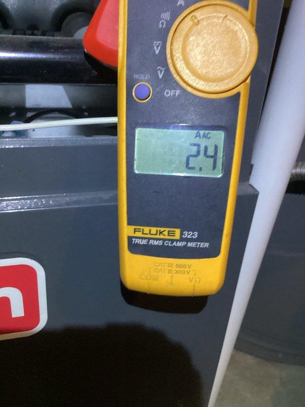 Completed comprehensive Green Shield cooling maintenance on 5-9 year old HVAC system with units located in basement and backyard. Performed standard preventive maintenance protocol including electrical diagnostics using Fluke 323 True RMS clamp meter, measuring voltage and amperage readings to verify proper system operation. Removed accumulated debris including dried grass and organic material from outdoor condenser unit that had collected in equipment crevices and openings. Inspected electrical connections, tested system performance parameters, and confirmed all components operating within manufacturer specifications. No issues reported by member prior to visit; system found to be functioning properly with all readings within normal range following maintenance completion.