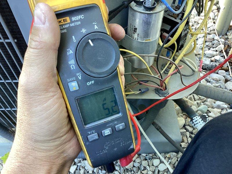 Completed annual air conditioner tune-up and preventative maintenance on residential rooftop unit under 5 years old. Performed comprehensive system inspection including electrical measurements using Fluke 902FC clamp meter, recording amperage draw of 5.2 amps. Inspected and tested capacitor connections and verified proper wire terminations across all electrical components. Conducted full system evaluation including visual inspection of all accessible components, checked refrigerant levels, and assessed overall unit operation. All systems found operating within normal parameters with no deficiencies noted. Unit left in proper working condition.