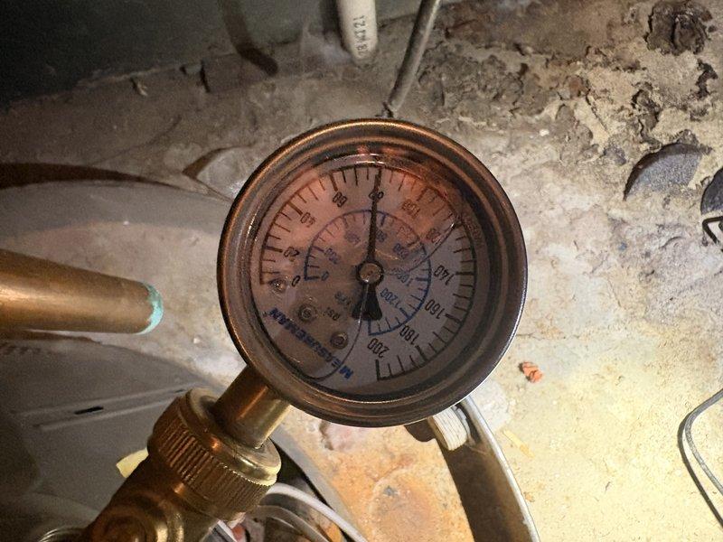 Responded to a no hot water call for a 5-year-old tanked water heater. Performed diagnostic assessment and documented existing system conditions, including pressure readings and installation configuration in utility area. Provided estimate for replacement with a 50-gallon tanked water heater with 12-year warranty, as customer declined repair options and requested replacement quote only.