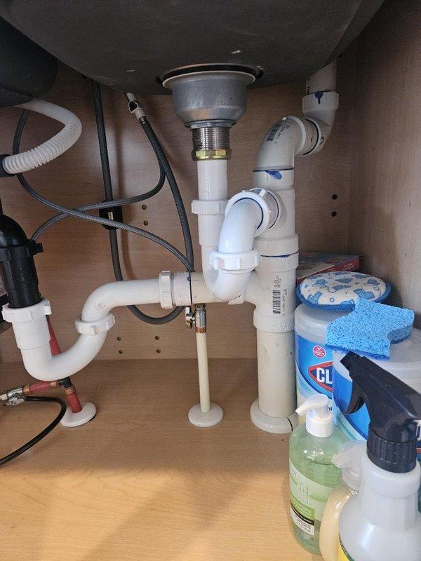 Completed comprehensive plumbing maintenance inspection under membership plan at residential condo unit. Performed thorough examination of tank-style water heater (4-5 years old), including visual assessment of all connections, valves, and piping infrastructure. Inspected kitchen sink plumbing assembly, including P-trap configuration, PVC drainage system, and chrome drain basket strainer for proper operation and potential issues.