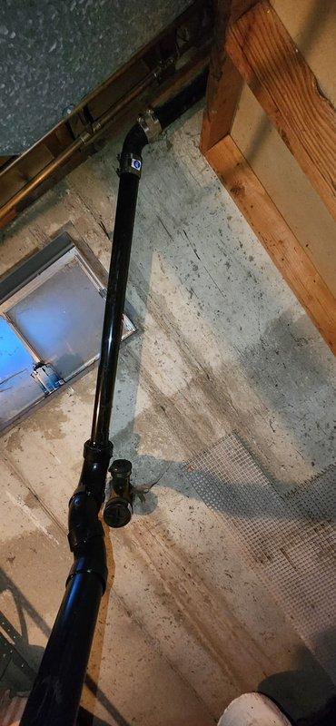 Completed full repipe of backgraded drain system, connecting kitchen drain line to new piping and capping off existing septic connection. Removed and reset two toilets with new flange connections at each location. Adjusted laundry drain P-trap to lower position to achieve proper drainage rise and code-compliant configuration.