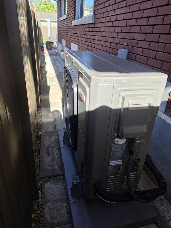 Completed full system HVAC installation including Lennox SLP99UH070XV36BK high-efficiency furnace, EL18KSLV-036 air conditioner, and CK40CT-30/36B-71 evaporator coil. Installed S40 thermostat with outdoor sensor, relocating thermostat to opposite side of wall and pulling new control wire from mechanical room to accommodate KSLV unit requirements. Mounted outdoor condensing unit on EL2448-3 pad with proper elevation using riser in narrow side yard access area between buildings. Flushed and reused existing refrigerant lineset, installed 20x25x5 filter cabinet with MERV 11 filter, and connected condensate drain to floor drain using PVC piping. All equipment properly wired, tested, and verified operational per manufacturer specifications.