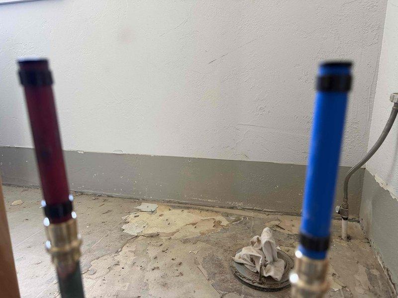 Responded to upstairs bathroom plumbing repair for shower system issues. Raised the copper shower head supply pipe to the proper height and repaired a malfunctioning four-way valve. Work required opening wall framing to access the vertical plumbing assembly and reconfiguring the pipe runs. Installed new valve components and secured all connections with proper fittings. Tested system for leaks and verified proper water flow and temperature control through all valve positions. All plumbing brought to code and left in full working order.
