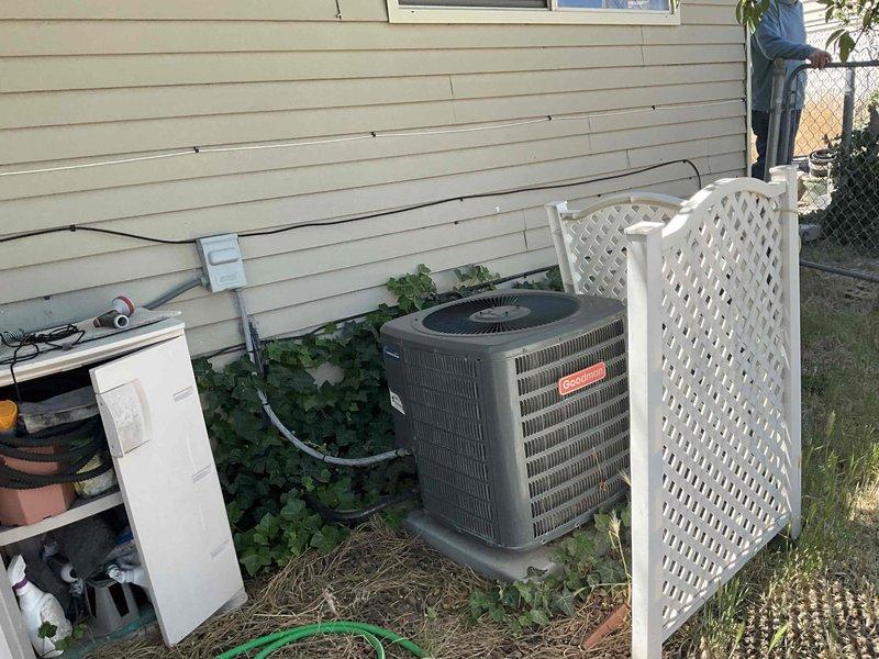 Responded to service call for 16-year-old residential cooling system experiencing insufficient cooling and reduced airflow, with thermostat set at 70°F but unable to achieve temperature below 75°F. Performed comprehensive diagnostic evaluation of single outdoor condensing unit and furnace system. Testing revealed condenser fan motor drawing excessive amperage beyond manufacturer specifications, indicating motor failure and potential compressor stress. Additional components found operating below specification parameters, compromising overall system efficiency and cooling capacity. Documented equipment condition through photographic evidence showing outdoor condensing unit installation and attic-mounted furnace configuration. Provided technical assessment and repair options for aging system requiring multiple component replacements to restore proper operation.