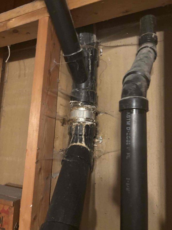 Responded to basement leak occurring during kitchen sink and garbage disposal usage, causing water to pool and spray near washing machine area. Conducted inspection and testing, identifying two visible cracks in the bottom 90-degree elbow of the main sewer stack as the source of the leak. Cut out and replaced the damaged cracked section of the drain pipe with new PVC piping and fittings, ensuring proper seal and alignment. Additionally replaced two deteriorated washer bibs with new fixtures to address secondary plumbing concerns noted during the service call.