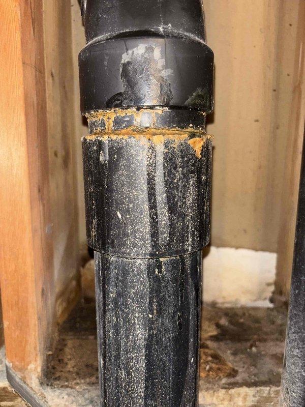 Responded to basement leak occurring during kitchen sink and garbage disposal usage, causing water to pool and spray near washing machine area. Conducted inspection and testing, identifying two visible cracks in the bottom 90-degree elbow of the main sewer stack as the source of the leak. Cut out and replaced the damaged cracked section of the drain pipe with new PVC piping and fittings, ensuring proper seal and alignment. Additionally replaced two deteriorated washer bibs with new fixtures to address secondary plumbing concerns noted during the service call.