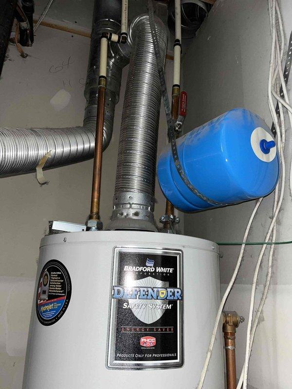 Responded to no hot water complaint on 2007 Bradford White tanked water heater with pilot light failure. Inspected unit and successfully relit pilot light using proper safety procedures. Verified burner ignition, flame characteristics showing proper blue combustion pattern, and confirmed thermocouple operation. Unit restored to full operational status with hot water production resumed.