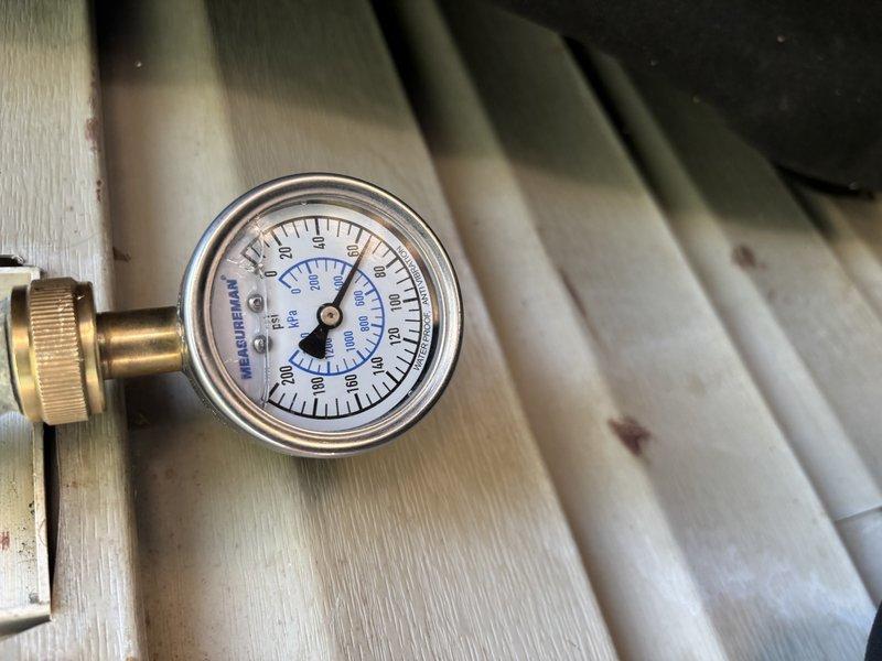 Responded to service call for 2-year-old tanked water heater experiencing error lights and pilot light failure. Performed diagnostic testing using multimeter to measure voltage and installed pressure gauge to assess gas control valve operation. Determined gas control valve had failed, causing intermittent pilot outage and error code display. Explained repair options including gas control valve replacement or full water heater replacement, noting that parts for this manufacturer model would require ordering directly from supplier with 2-7 day lead time. Scheduled return visit pending parts arrival to complete valve replacement and restore unit to proper operation.