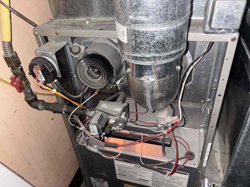 Completed comprehensive maintenance inspection on 15+ year old single-stage gas furnace system. Performed visual inspection of all internal components including blower motor assembly, gas valve, ignition system, and electrical connections. Inspected ductwork for dust accumulation and verified proper airflow pathways. Evaluated air filter condition and confirmed proper installation with correct directional orientation. Assessed overall system operation and provided status update on unit condition, noting normal wear patterns consistent with age of equipment.