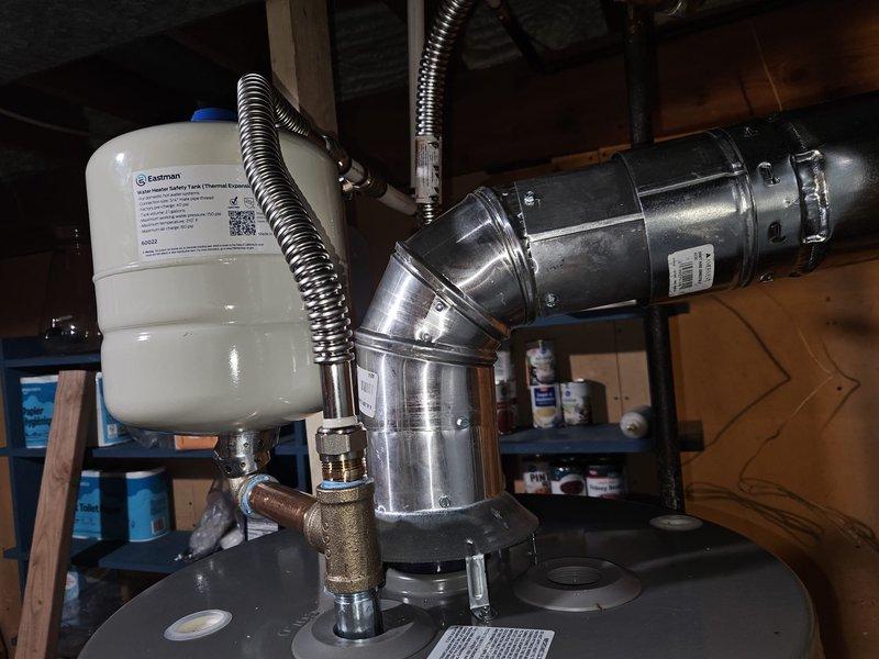Installed 40-gallon water heater in attic space with full code compliance including proper venting, gas line connections, expansion tank, and earthquake straps. Replaced old unit, installed new supply lines with shut-off valve, secured all components to structural beams, and completed lighting and testing procedures to verify proper operation.