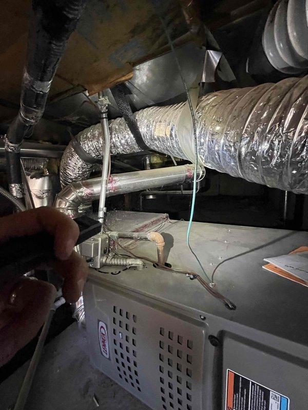 Responded to no hot water complaint and inspected 20+ year old tank-style water heater located in crawl space. Assessed unit condition and confirmed age beyond expected service life, documented equipment with photos for replacement estimate. Provided customer with repair versus replacement options for aging water heater system.