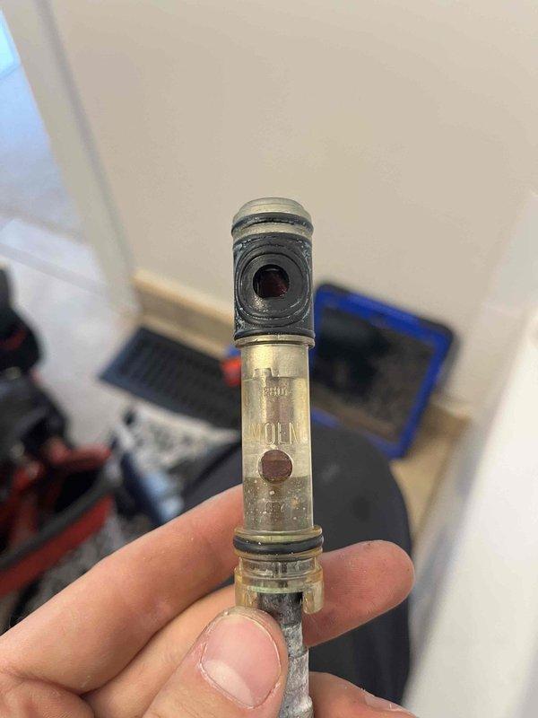 Responded to report of water leaking from beneath tub spout and around faucet handle in master bathroom shower/tub combination. Upon inspection, identified faulty shower diverter valve assembly causing water to bypass seals and leak at multiple points during operation. Removed existing worn diverter cartridge, which exhibited significant mineral buildup and deteriorated internal seals contributing to the leak. Installed replacement diverter assembly and tested operation to confirm proper water flow direction and complete elimination of leaks at both tub spout and handle locations.