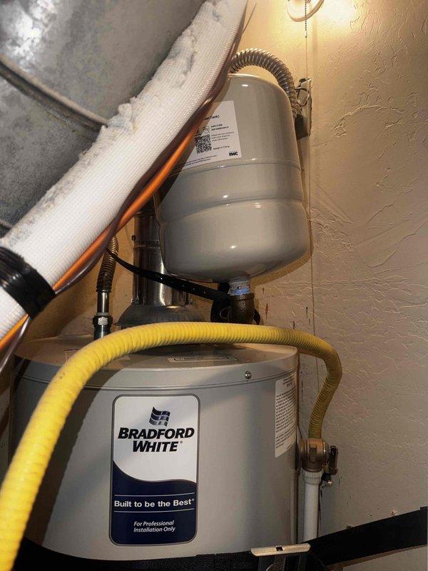 Completed annual air conditioning maintenance tune-up as part of membership service. Performed comprehensive system inspection including visual examination of furnace blower motor assembly, electrical connections, and control board. Verified proper operation of all internal mechanical components and checked wire connections throughout the unit. Inspected water heater installation in attic space, confirming proper mounting of expansion tank, secure gas line connections via yellow corrugated flex line, and integrity of copper piping with foam insulation. All systems found operating within normal parameters with no deficiencies noted.
