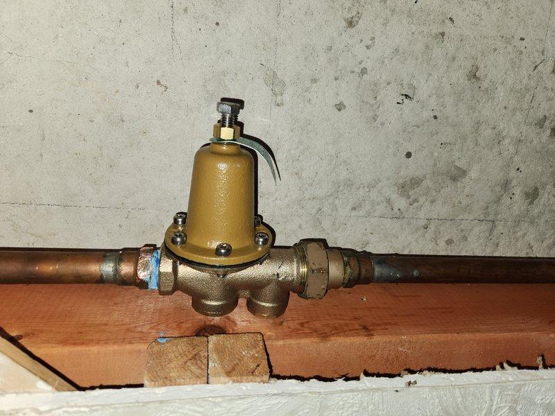 Responded to service call for 4-year-old tankless water heater in basement producing only lukewarm water instead of hot water. Inspected unit and associated plumbing components including pressure reducing valve assembly on copper supply lines. Diagnosed issue, performed necessary adjustments or repairs to restore proper hot water temperature output to whole home system.