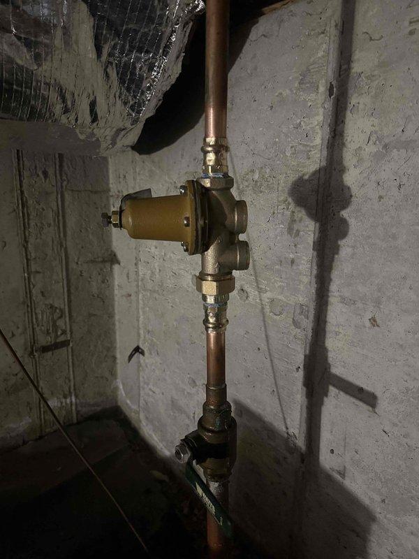 Completed installation of 40-gallon water heater in basement utility area with all required code compliance measures including proper venting, thermal expansion tank, and seismic restraint straps. Removed existing water heater, installed new copper supply lines with shutoff valve, connected gas line with brass valve assembly, and verified proper operation through lighting and testing procedures.