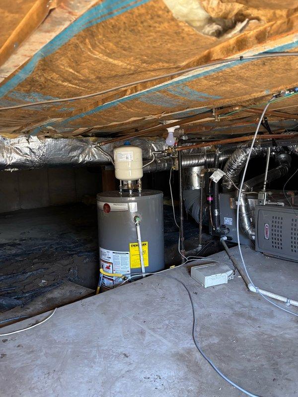 Completed installation of 40-gallon water heater in basement utility area with all required code compliance measures including proper venting, thermal expansion tank, and seismic restraint straps. Removed existing water heater, installed new copper supply lines with shutoff valve, connected gas line with brass valve assembly, and verified proper operation through lighting and testing procedures.