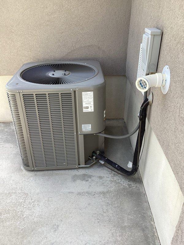 Completed comprehensive maintenance inspection on 8-year-old split system including both furnace and air conditioning equipment. Performed standard tune-up procedures on outdoor condensing unit located in backyard alcove and indoor furnace system in basement. During inspection, identified dirty outdoor coil requiring cleaning, dual run capacitor testing below minimum rating specifications, and elevated compressor startup amperage. Documented vibrating blower wheel in air handler indicating potential bearing wear or imbalance. Recommended capacitor replacement and hard start kit installation to address compressor electrical concerns and extend equipment lifespan. Presented UV air scrubber option for enhanced indoor air quality improvement. Unit currently operational with no immediate system failures, though identified components warrant attention to prevent future service interruptions. Photographic documentation captured of outdoor unit installation, refrigerant line routing, electrica