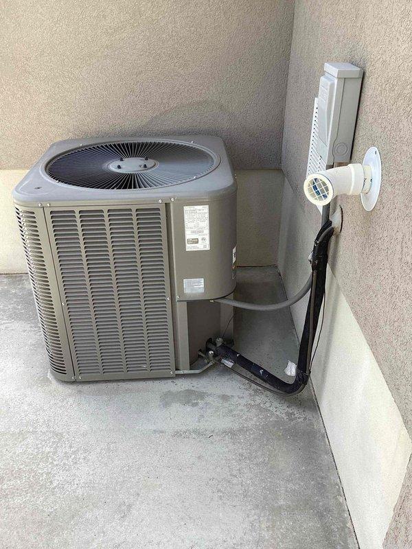 Completed comprehensive maintenance inspection on 8-year-old split system including both furnace and air conditioning equipment. Performed standard tune-up procedures on outdoor condensing unit located in backyard alcove and indoor furnace system in basement. During inspection, identified dirty outdoor coil requiring cleaning, dual run capacitor testing below minimum rating specifications, and elevated compressor startup amperage. Documented vibrating blower wheel in air handler indicating potential bearing wear or imbalance. Recommended capacitor replacement and hard start kit installation to address compressor electrical concerns and extend equipment lifespan. Presented UV air scrubber option for enhanced indoor air quality improvement. Unit currently operational with no immediate system failures, though identified components warrant attention to prevent future service interruptions. Photographic documentation captured of outdoor unit installation, refrigerant line routing, electrica