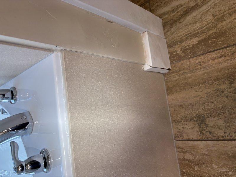 Responded to reported leak in master bathroom originating from bathtub area and manifesting under baseboard. Accessed plumbing infrastructure through attic/crawl space and inspected PEX water supply lines, compression fittings, and brass connectors serving the bathtub fixture. Replaced defective fittings and connections on blue PEX supply lines to eliminate leak source. Verified all chrome dual-handle faucet connections at tub surround were properly sealed and operational upon completion.