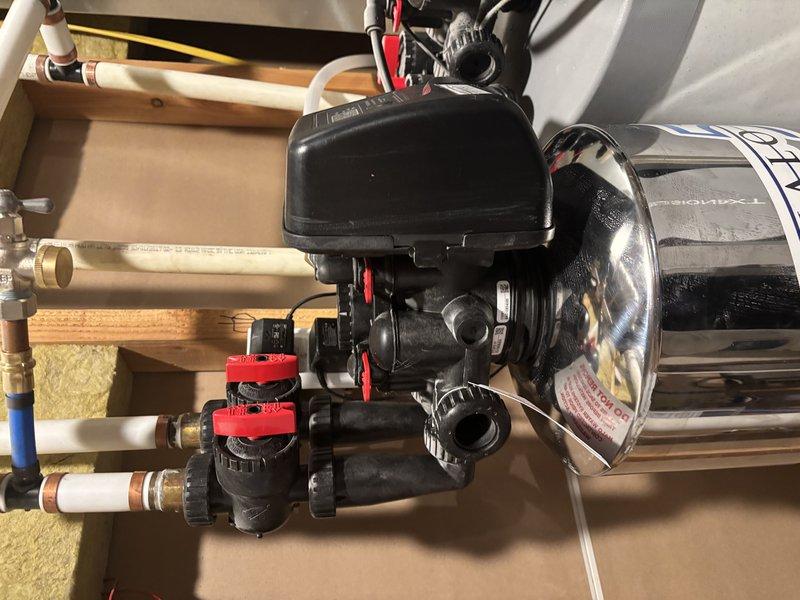 Performed diagnostic inspection of recently installed HALO whole home water filtration system in basement furnace room following concerns about unit stability and alignment. Inspected all mounting brackets, connection points, and plumbing interfaces on the cylindrical filtration unit to verify proper installation per manufacturer specifications. Confirmed all pipe connections, including insulated water lines and PVC plumbing, were secure with no signs of leakage or improper fitting. Evaluated system pressure, flow direction, and shutoff valve operation to ensure full functionality. Unit found to be properly installed and operating as intended with all components secure and stable.
