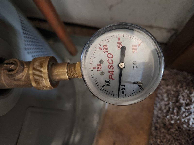 Responded to callback for loud humming noise in upstairs bathroom following recent pressure gauge replacement on 35-year-old plumbing system. Inspected pressure gauge reading approximately 150 psi and verified proper installation of brass fittings and copper piping connections. Examined toilet tank components including flapper valve, float mechanism, and flush assembly for potential vibration or noise sources. Documented system conditions with photographic evidence showing pressure gauge operation and toilet tank interior. Provided previous invoice documentation as requested and updated contact information for future service records.